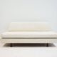 Italian modernist daybed with white upholstery and iron frame.