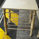 Patinated metal and wood double bed with integrated bedside tables.