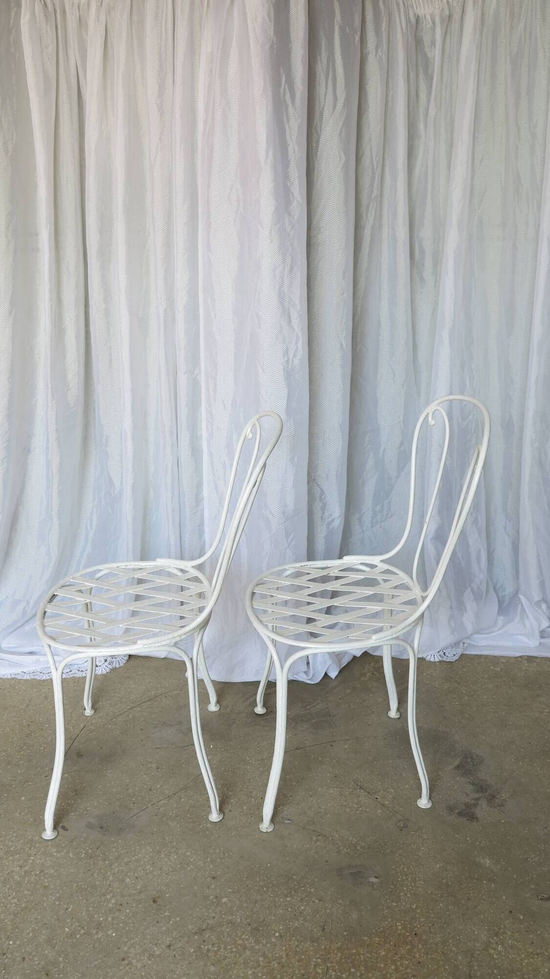 Pair of antique garden chairs, wrought iron, white paint.