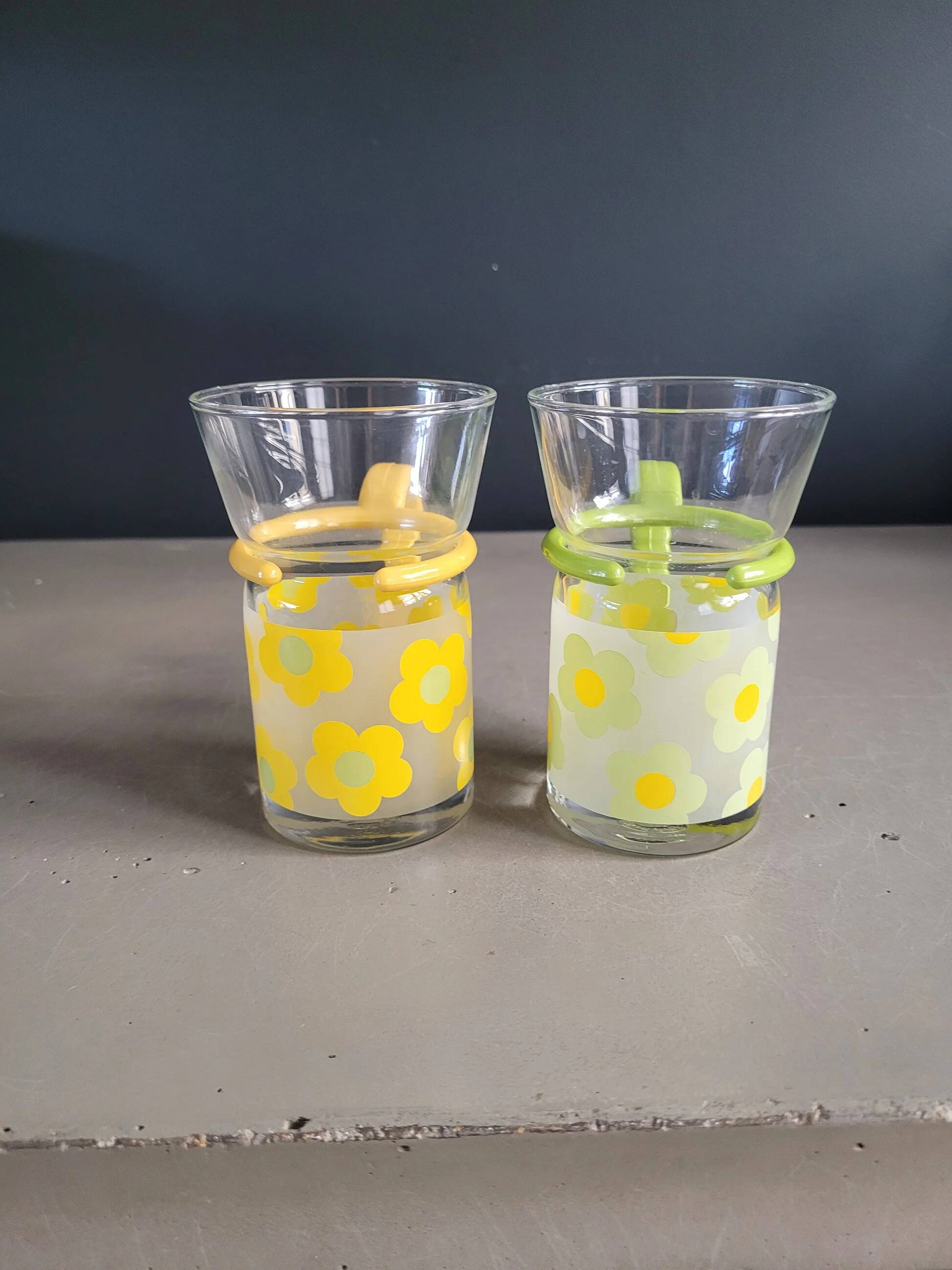 Pair of glass teacups with plastic handles