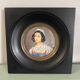 Old miniature portrait painting of a woman.