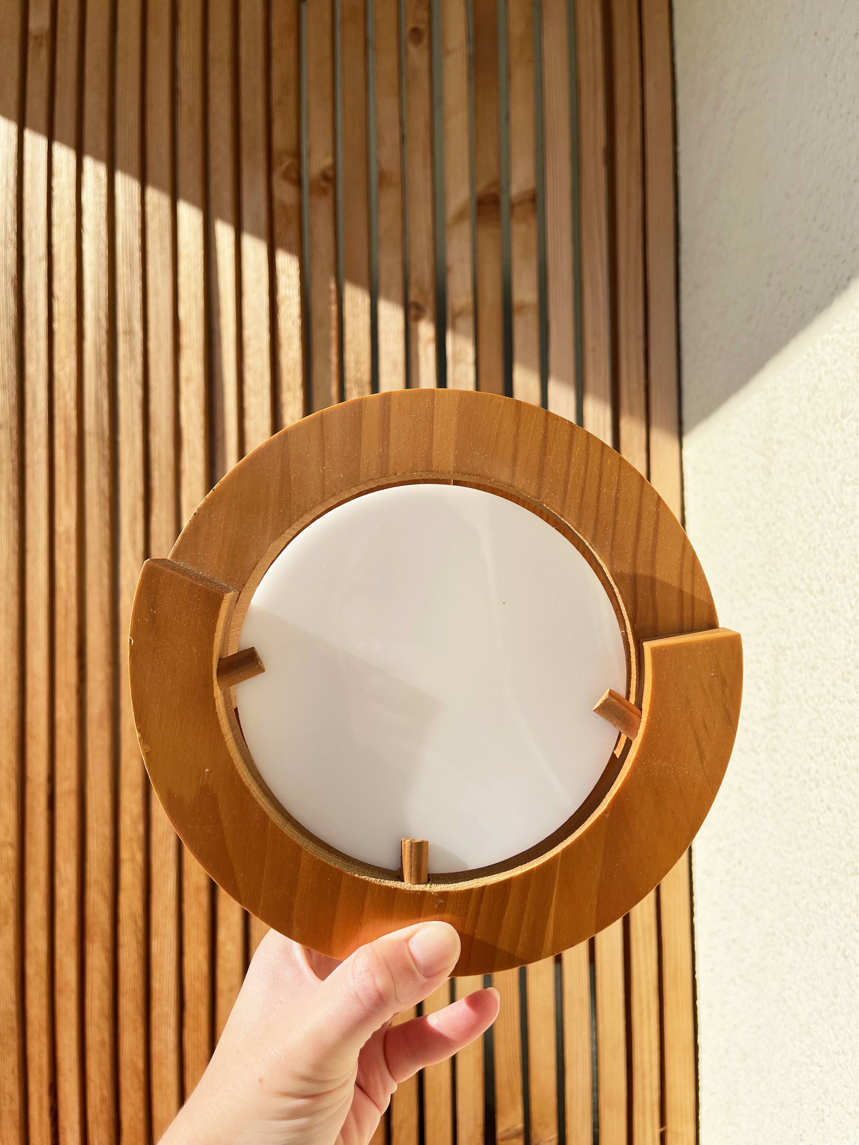 Round pine and plexiglass wall light, 1970s