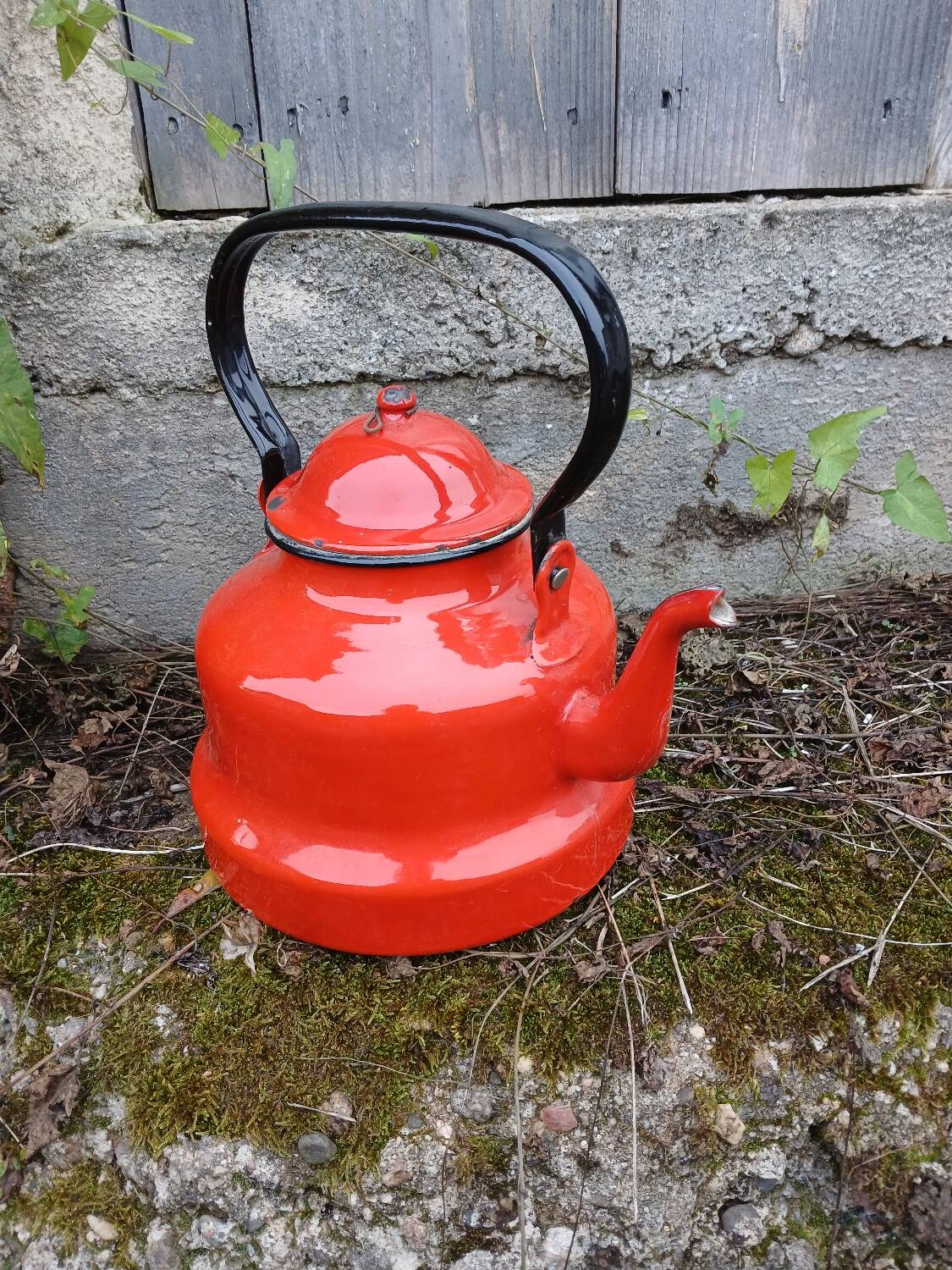 Antique teapot in red enamelled sheet metal