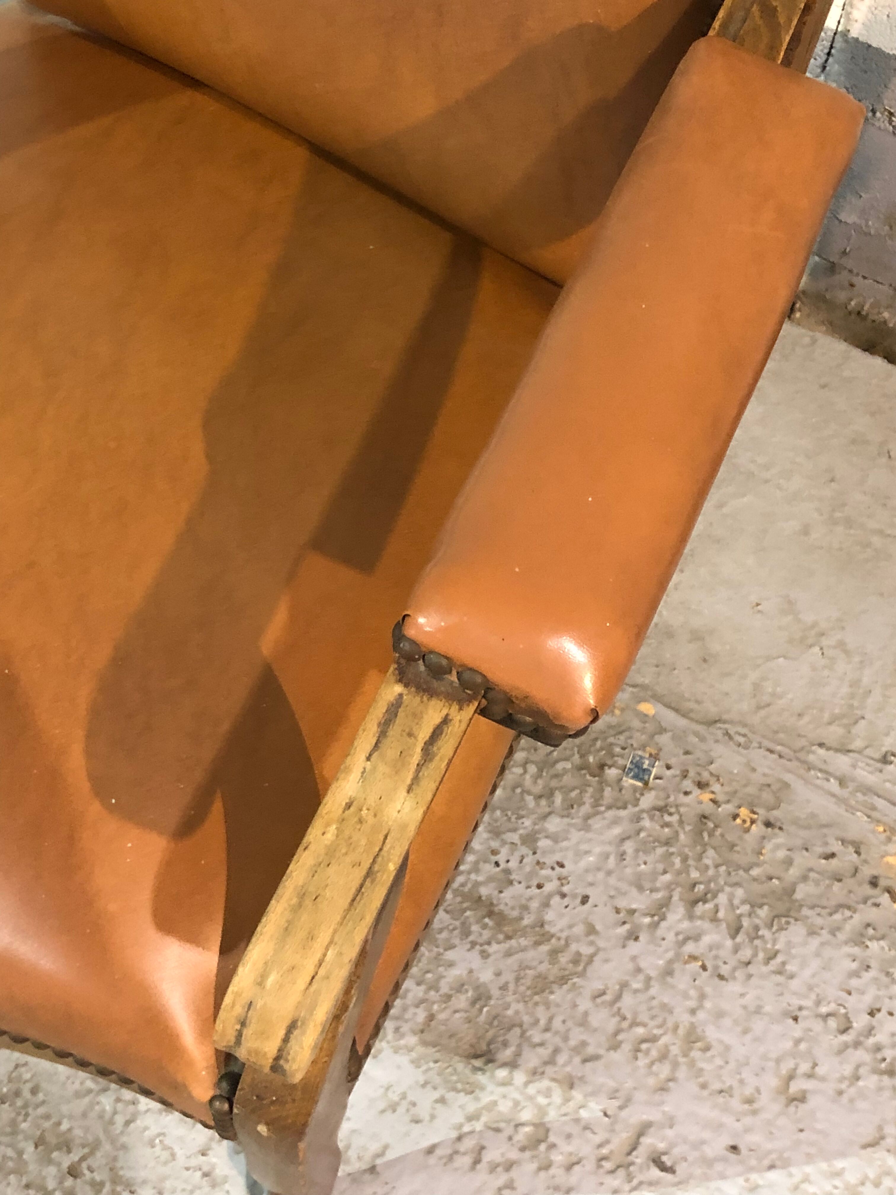 Old Voltaire armchair in light brown leather