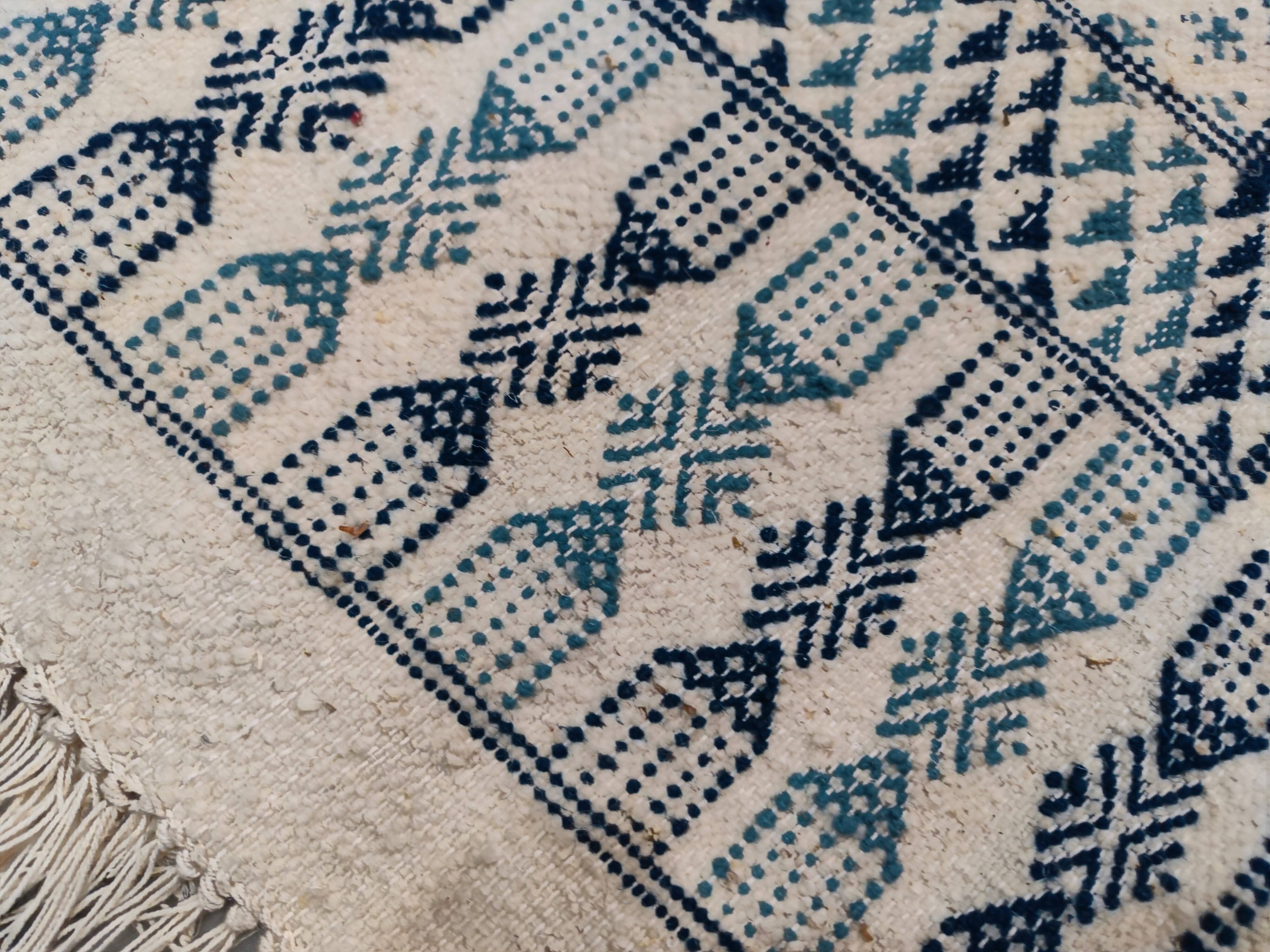 White and blue handwoven rug in natural wool