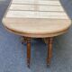 Round extendable dining table Napoleon III renovated in 19th-century oak.