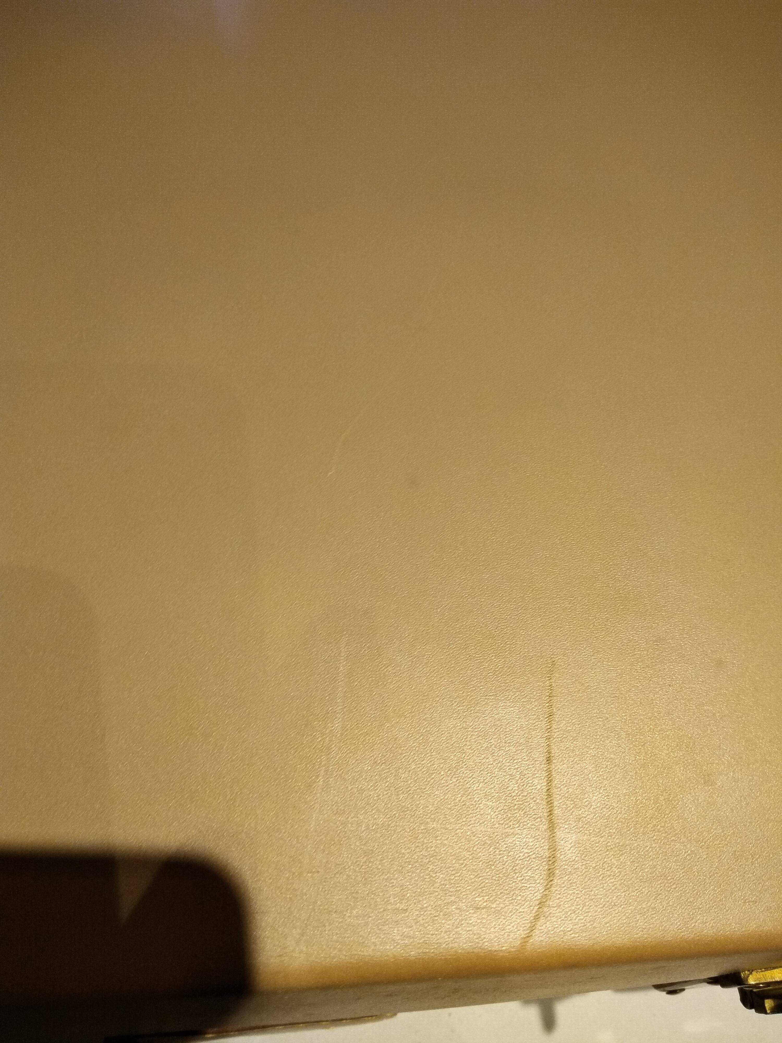 Old leather suitcase with its protective cover