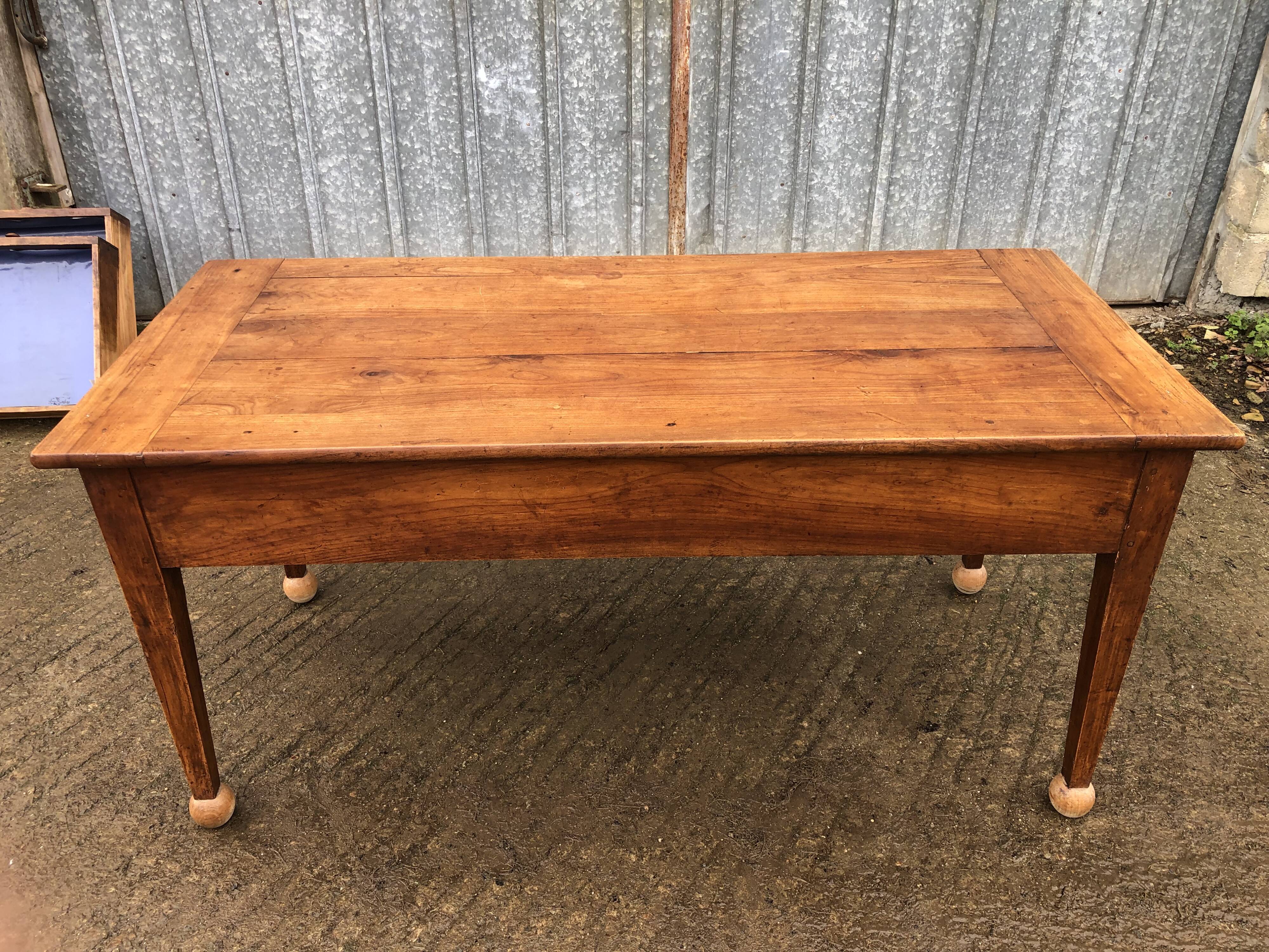 Antique solid cherry farmhouse table with 2 end drawers and 1 pull-out.