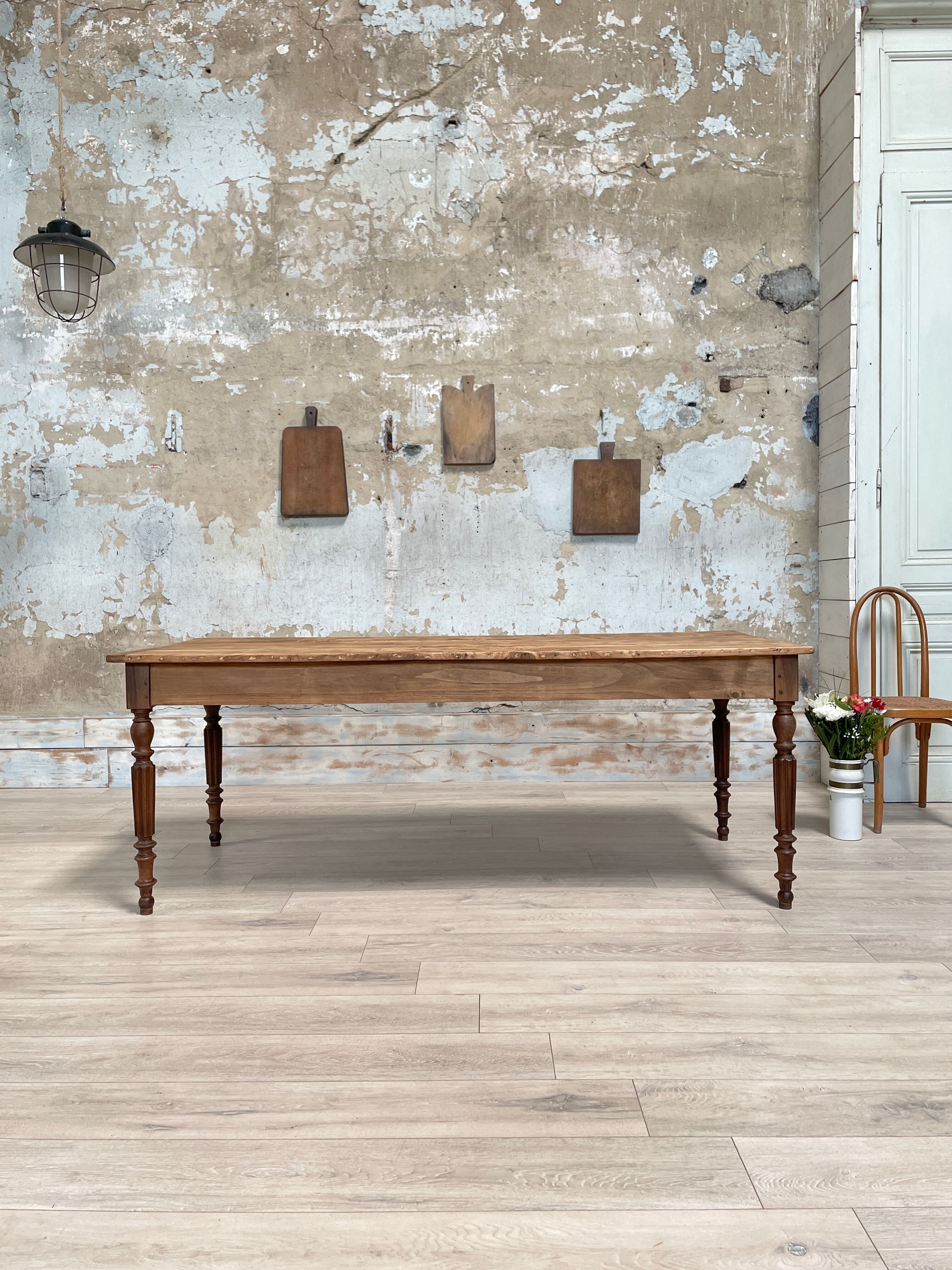 Vintage farmhouse table with turned legs.