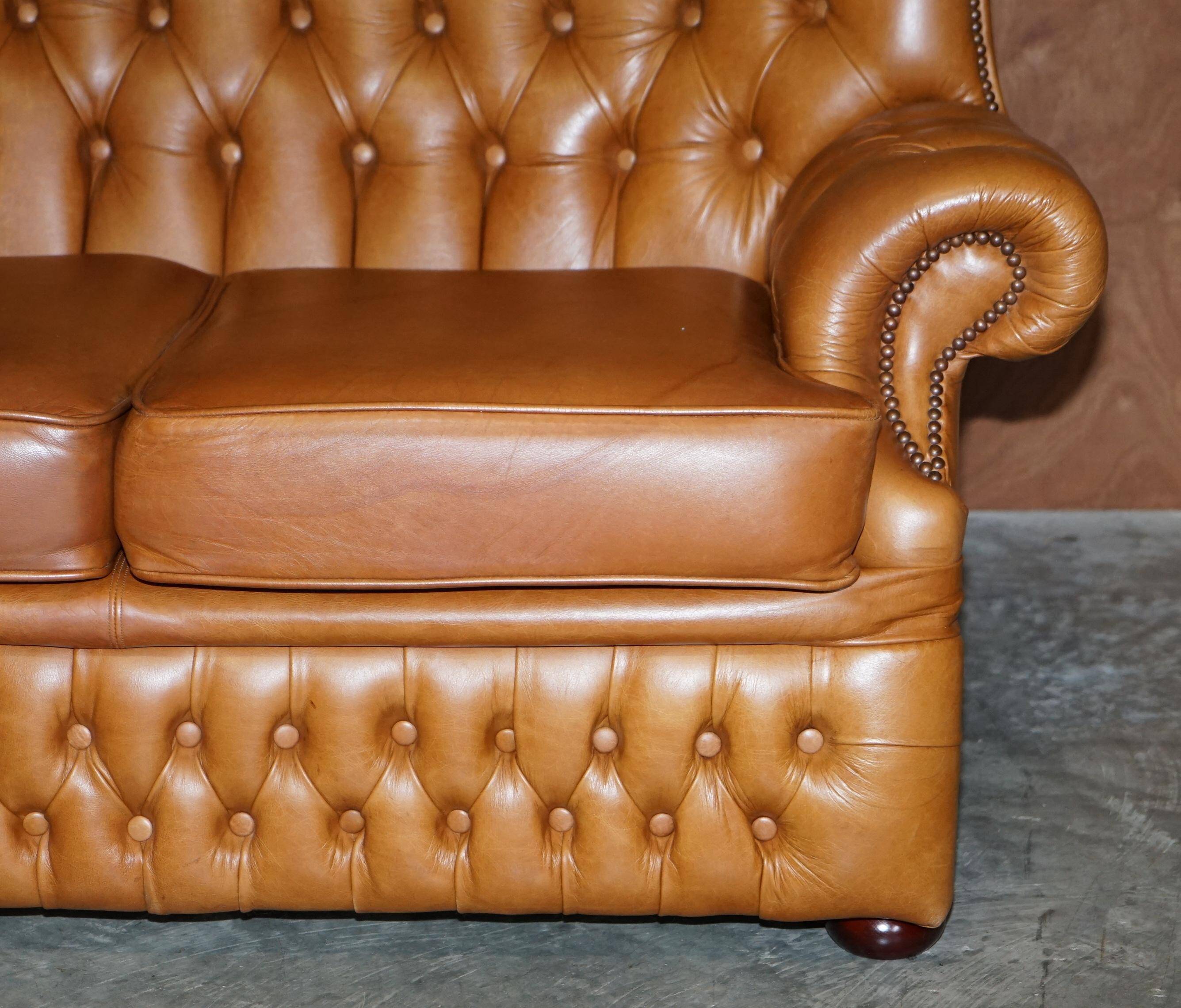 Small Chesterfield leather sofa with a high back.
