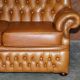 Small Chesterfield leather sofa with a high back.