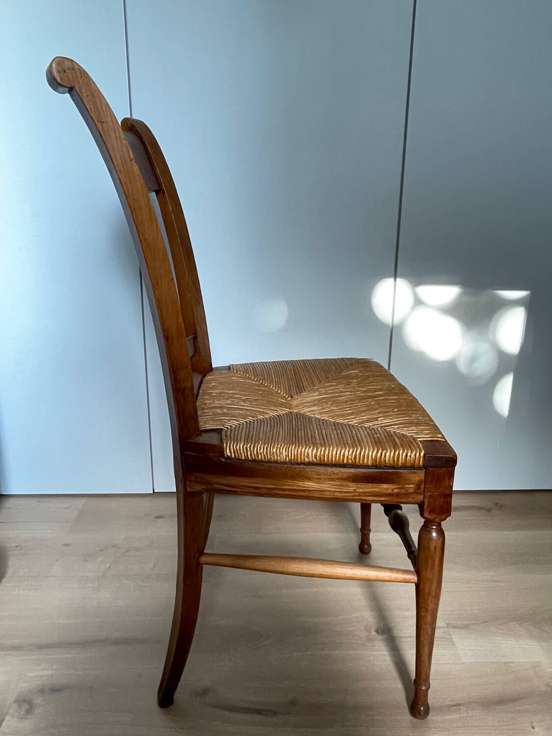19th century straw chair with carved peacock back