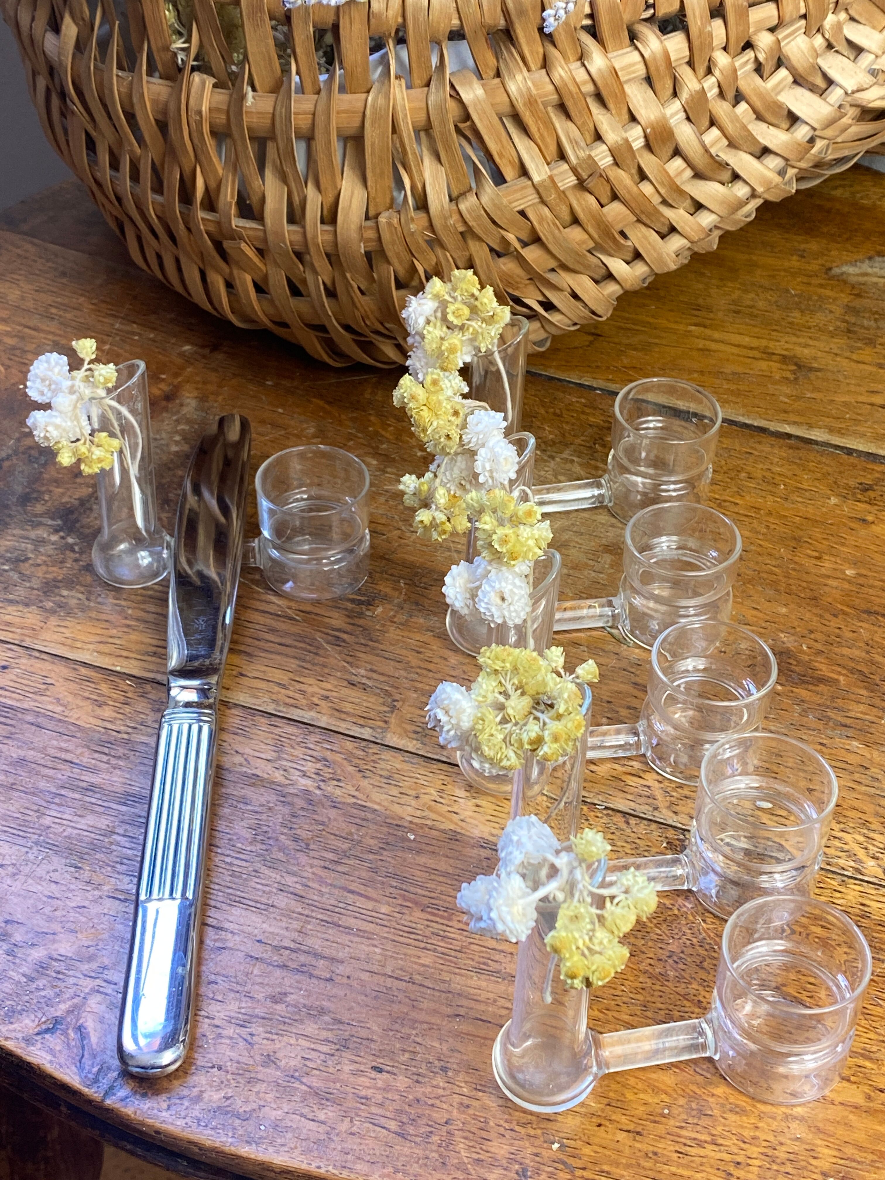 Knife rests, flower vases and candle holders in blown glass.