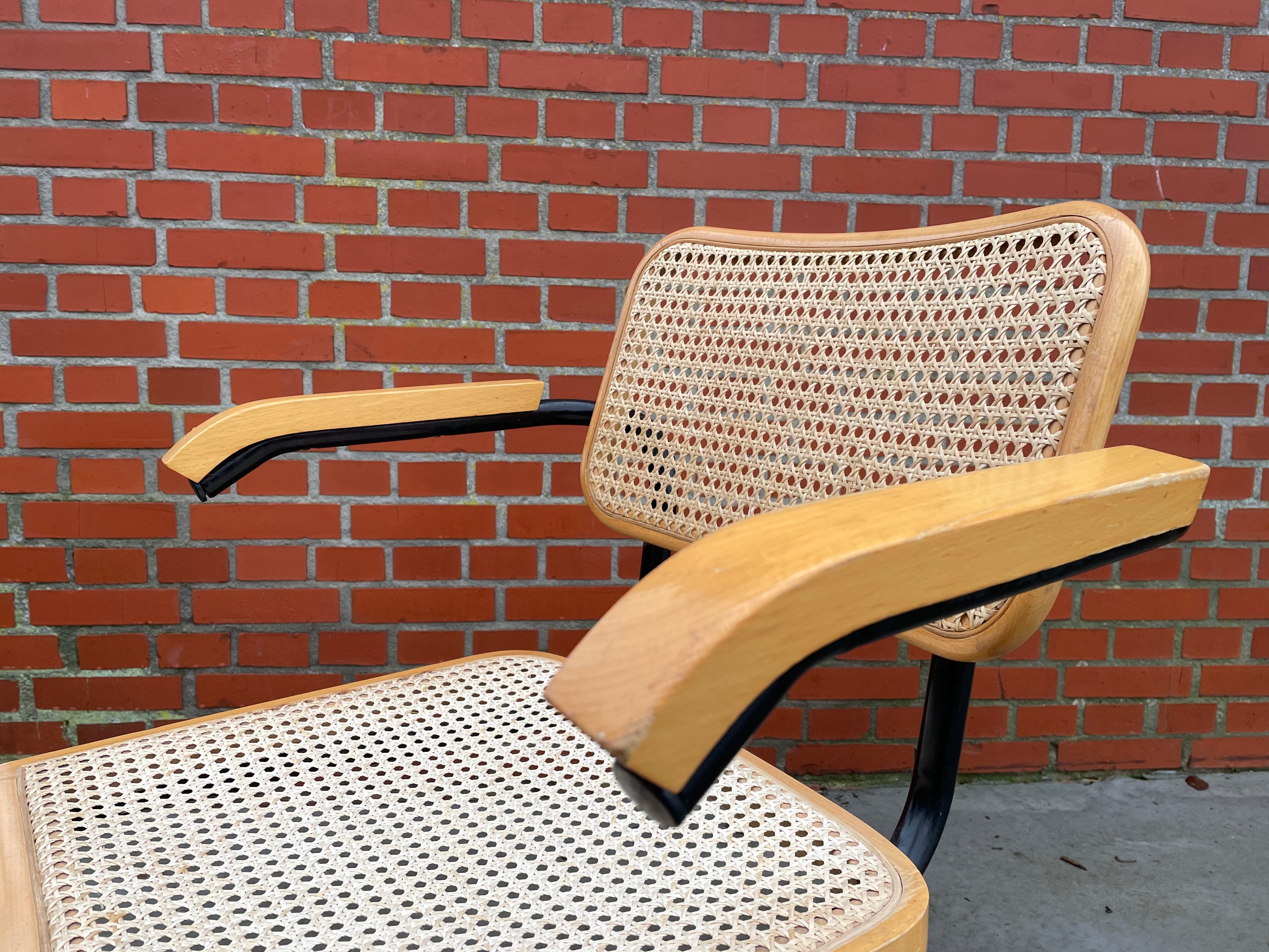 Cesca model chair designed by Marcel Breuer with black-framed armrests