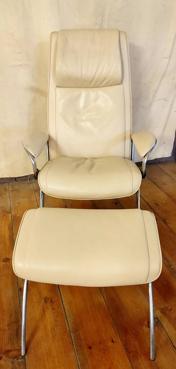 Beige leather armchair and footstool