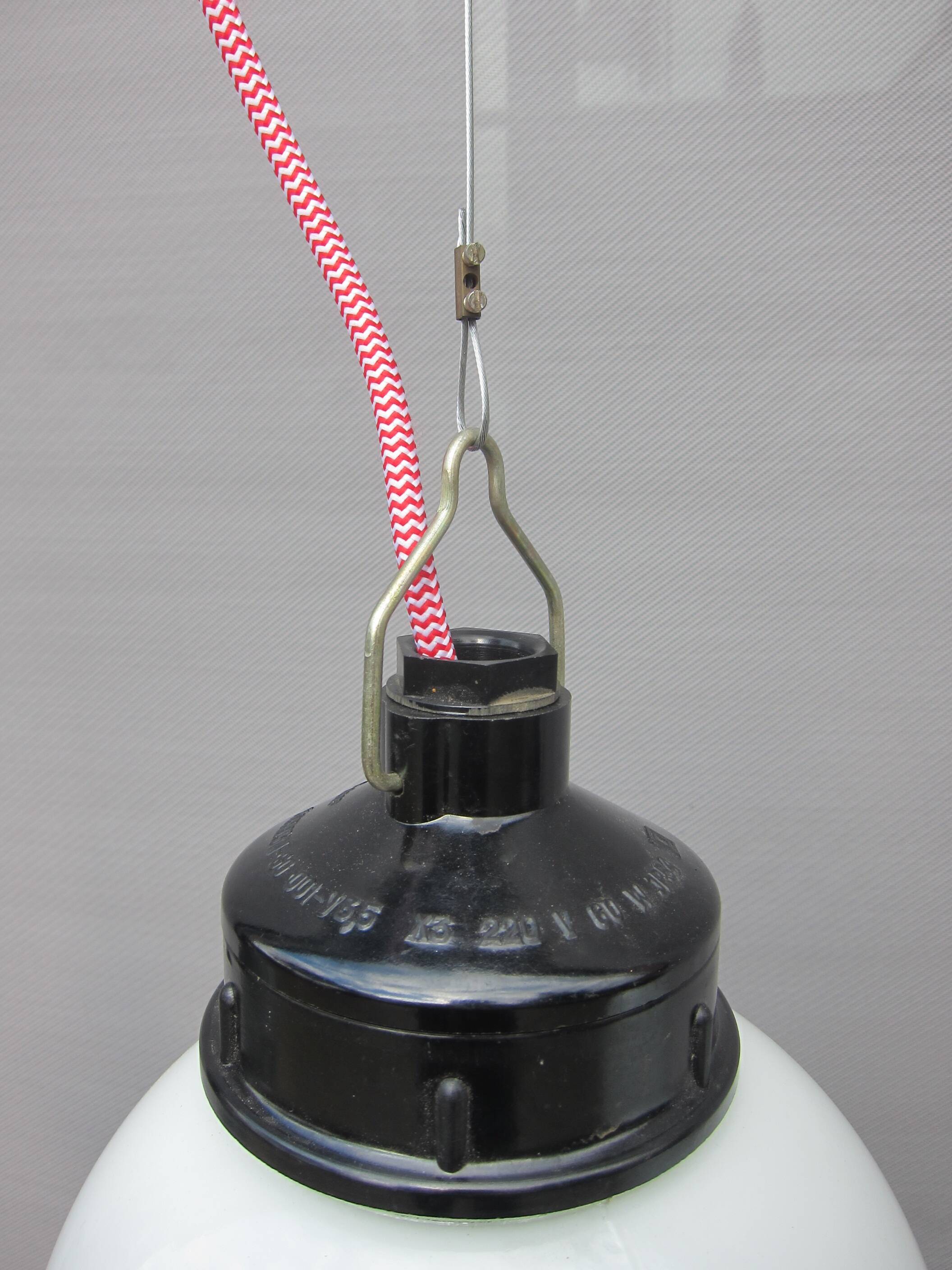 Trio of opal glass and bakelite globe pendant lights