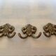 Three double brass coat hooks.