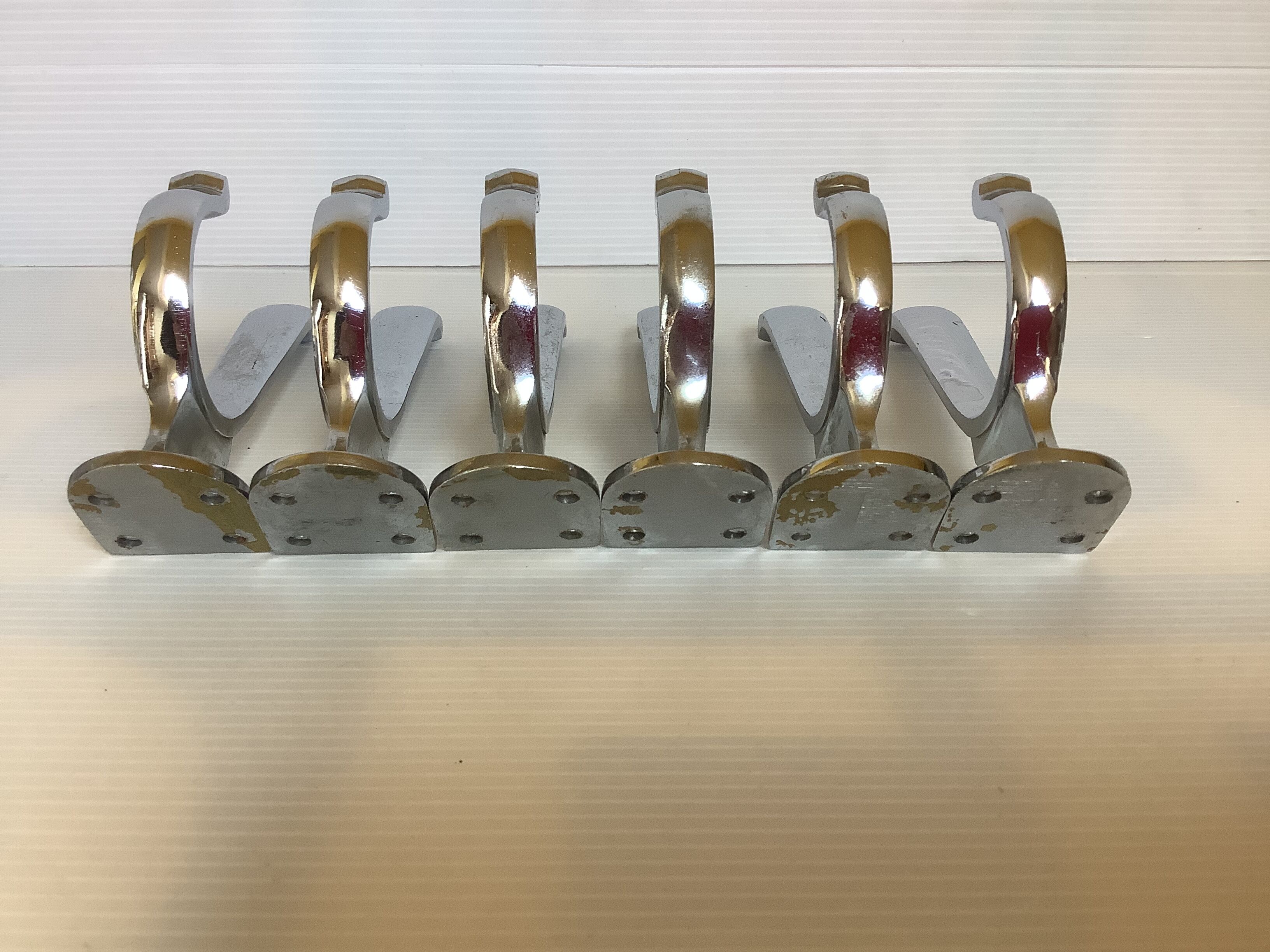 Six old chrome-plated metal hooks