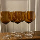 6 amber stemmed glasses