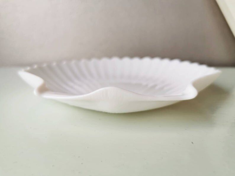 White ceramic dish shaped like 80s shells