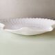 White ceramic dish shaped like 80s shells