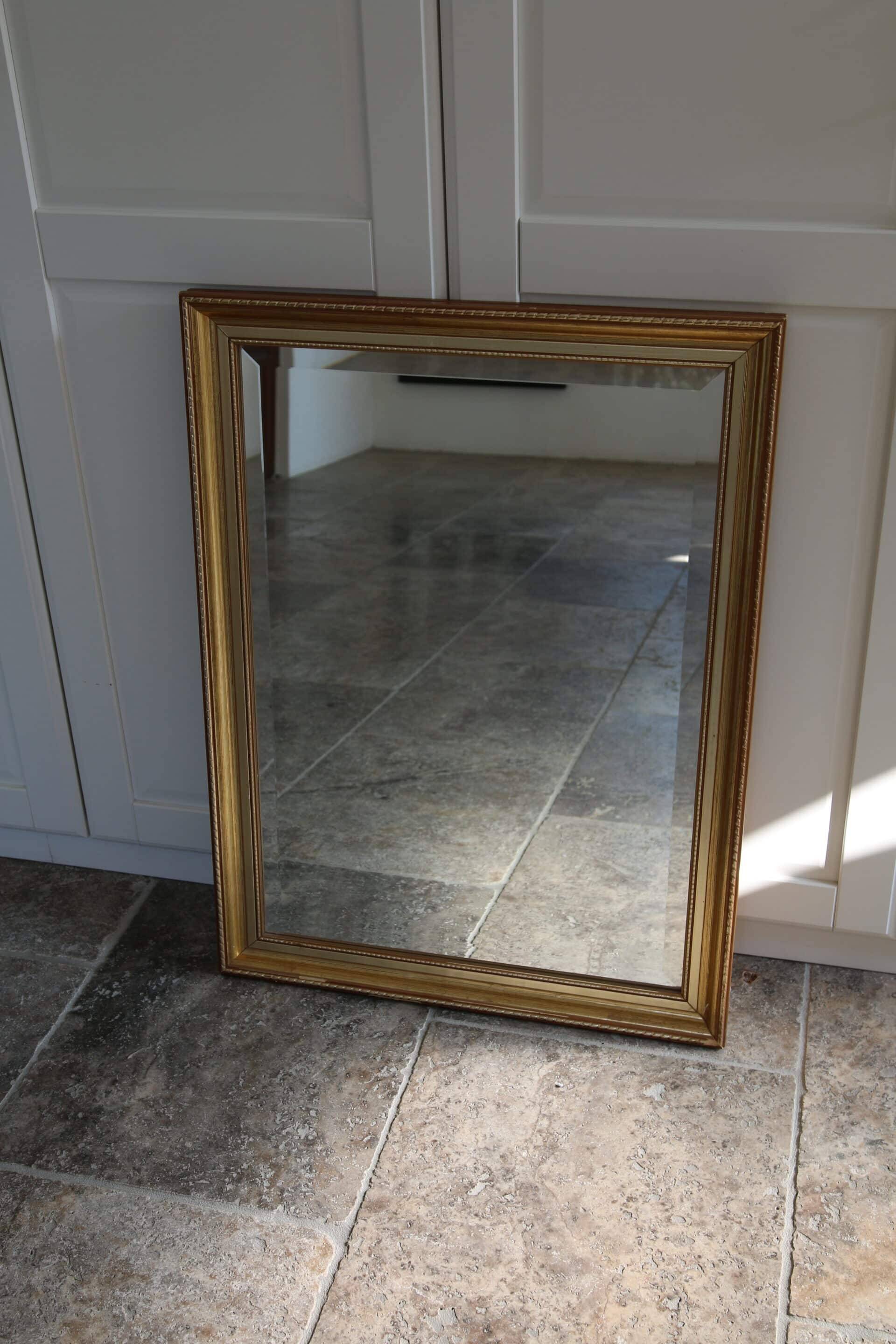 Large beveled mirror in carved wood