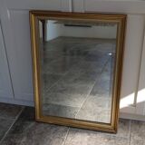 Large beveled mirror in carved wood