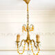 Small vintage brass chandelier with amber crystal pendants.