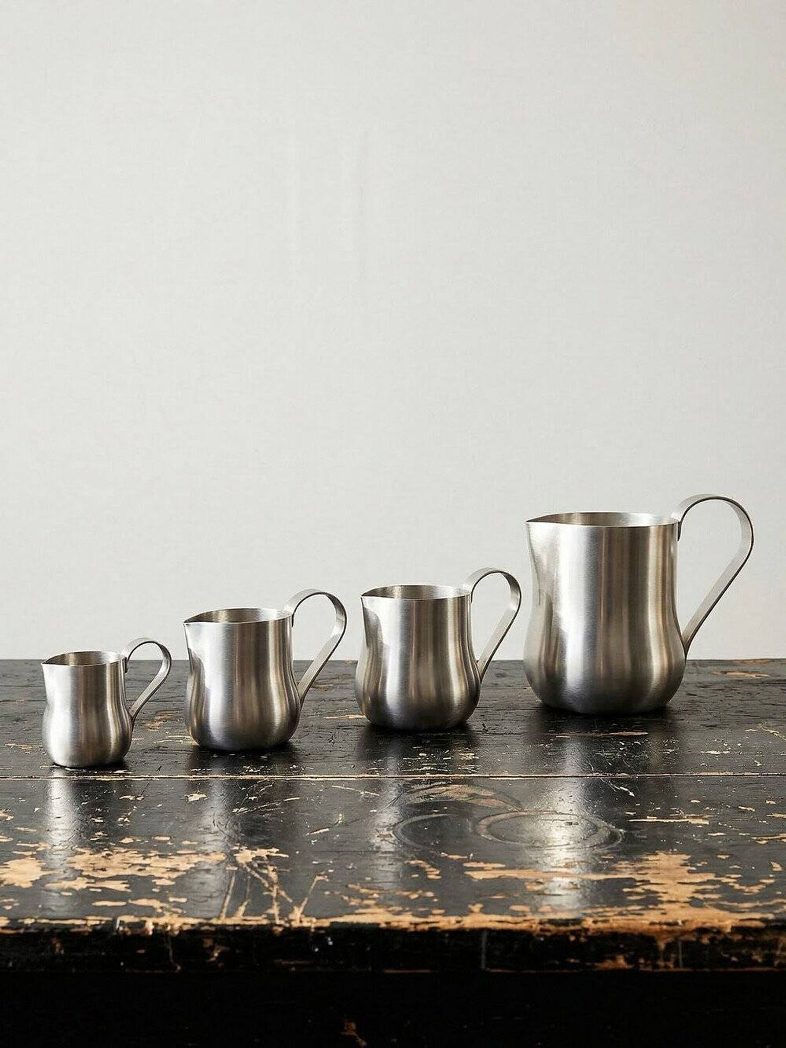 Set of 4 vintage bar measures in brushed stainless steel from the 60s-70s.