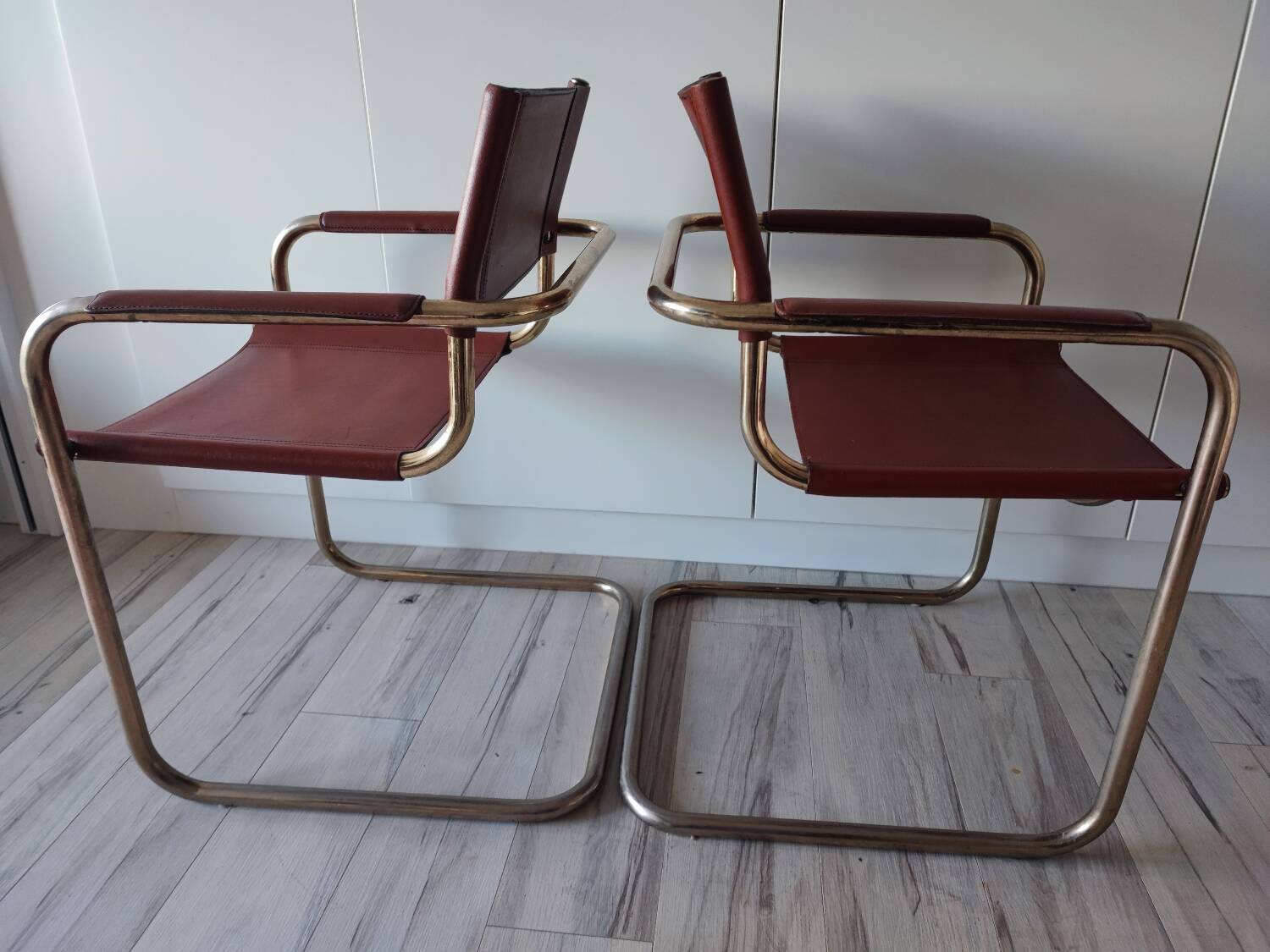 B34 armchairs, cognac leather and gilding
