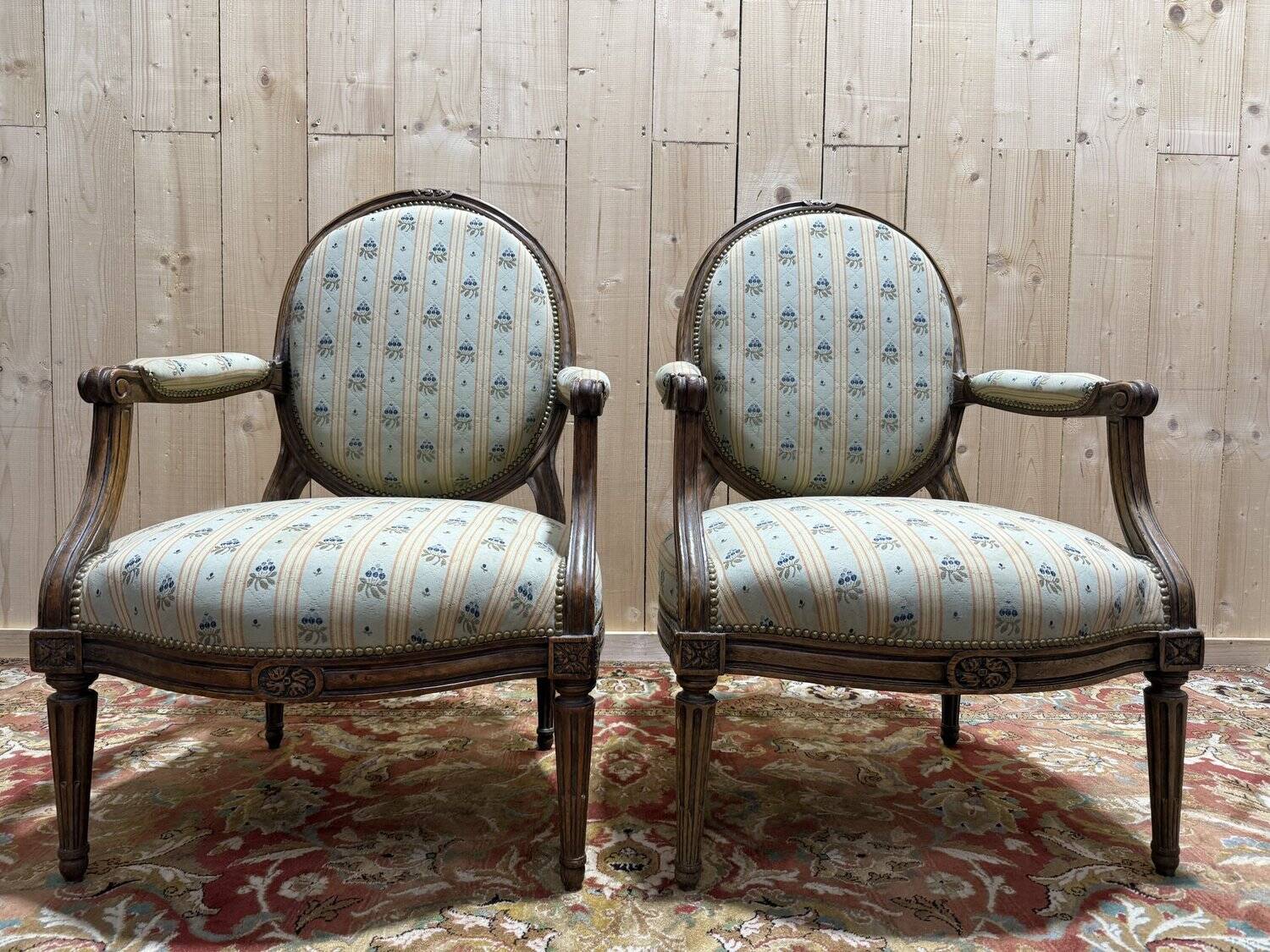 Pair of cabriole armchairs with medallion backs from the Louis XVI period, stamped OT.
