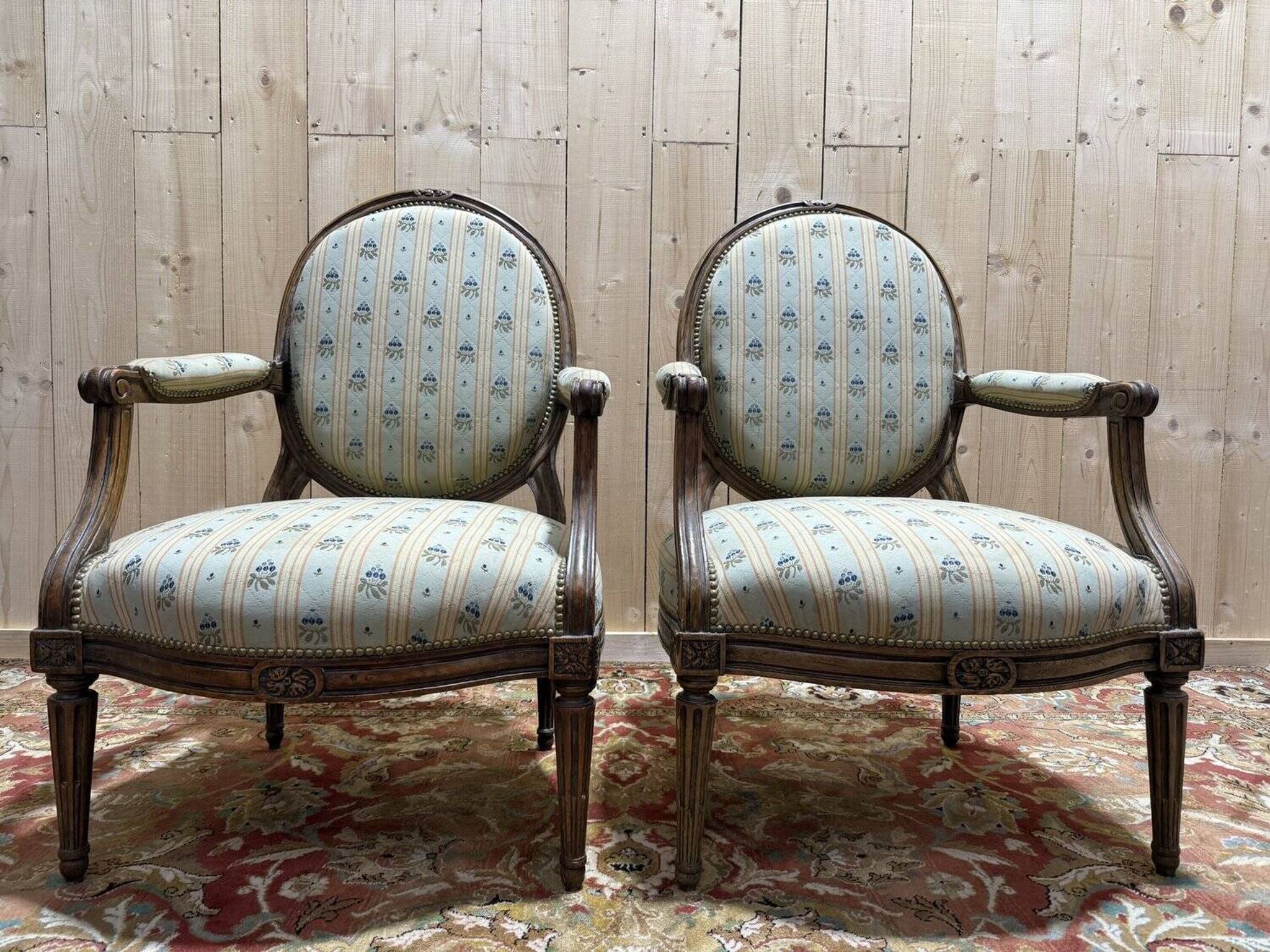Pair of cabriole armchairs with medallion backs from the Louis XVI period, stamped OT.
