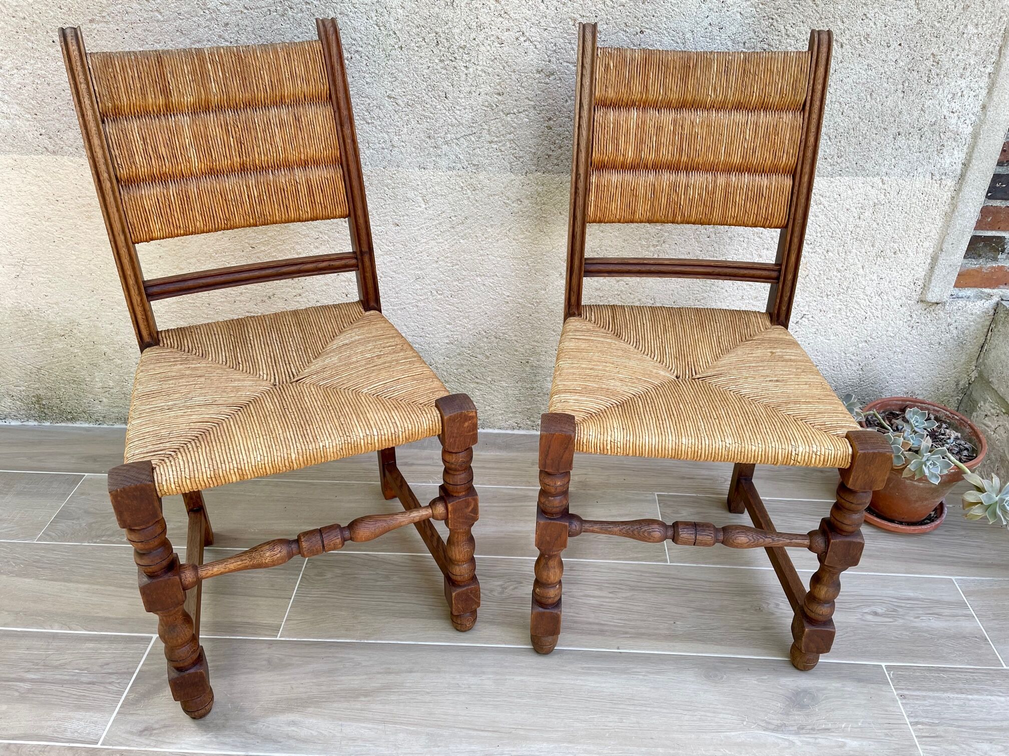 Pair of straw and solid oak chairs