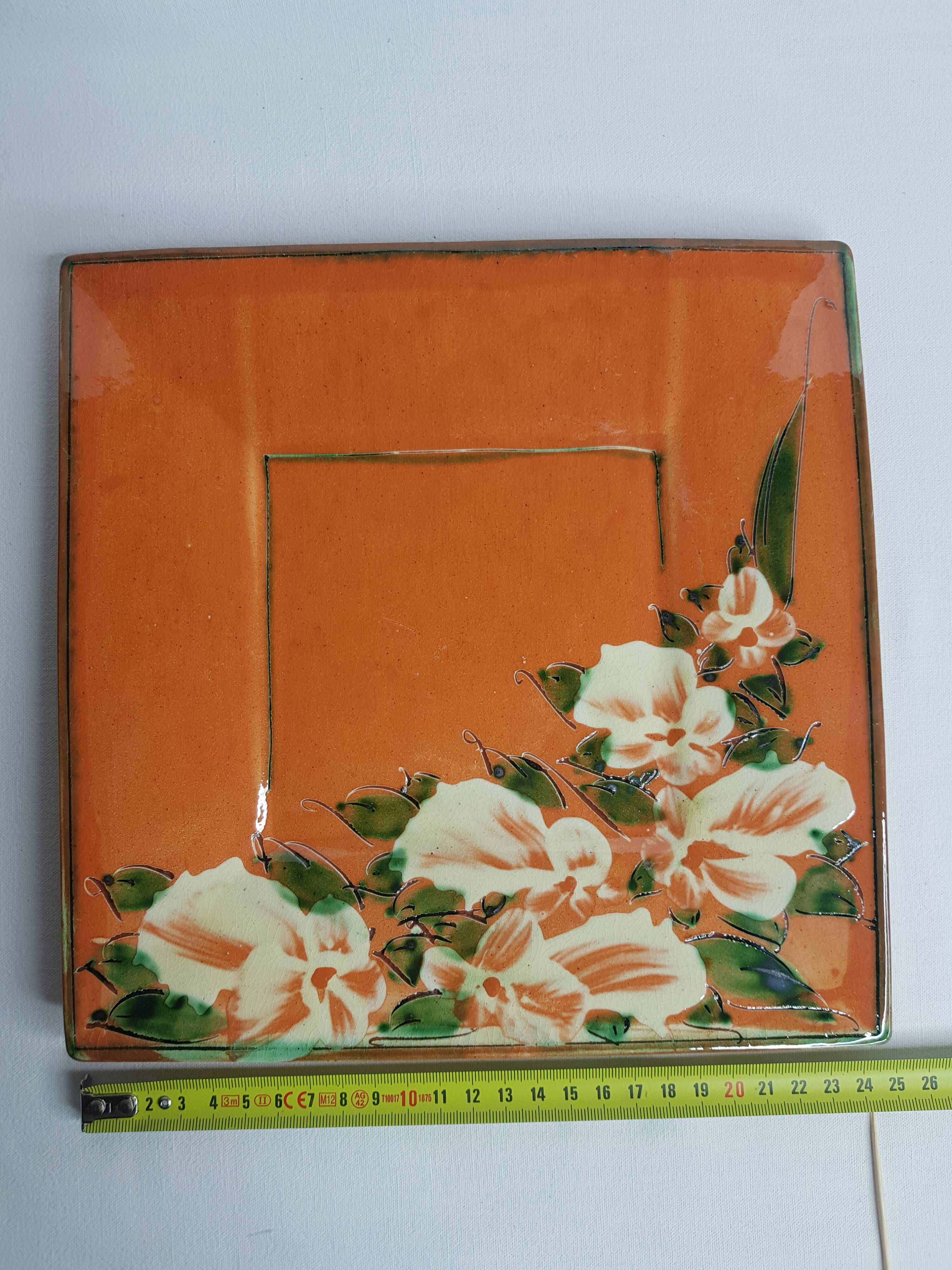Dish or plate Pottery Galtié enamelled terracotta decorated with flowers, 24.5 cm