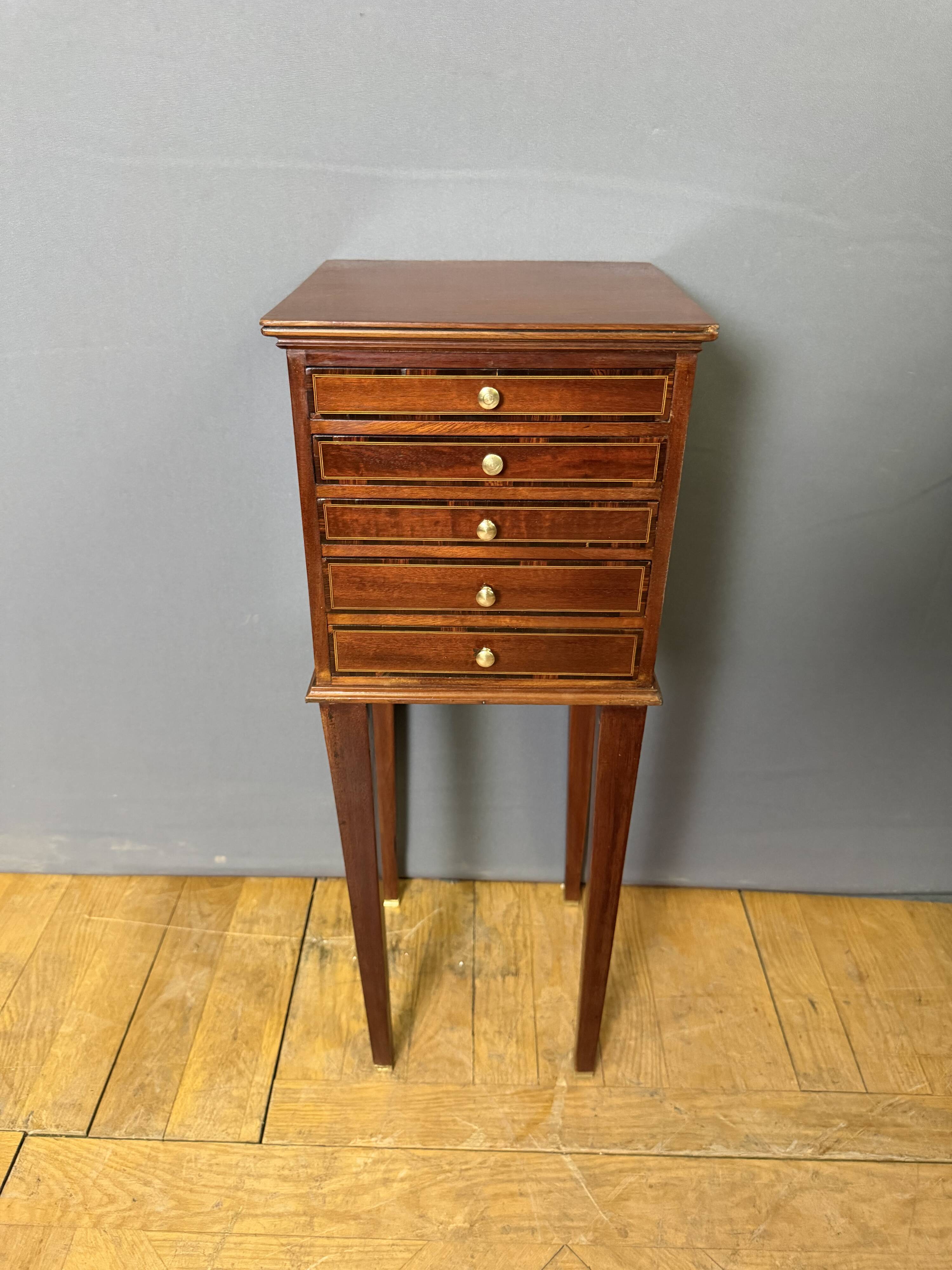 Louis XVI bedside table in mahogany with five drawers.