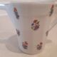 Large milk jug and sugar bowl from the 1930s, decorated with a bouquet of flowers. Silver thread.