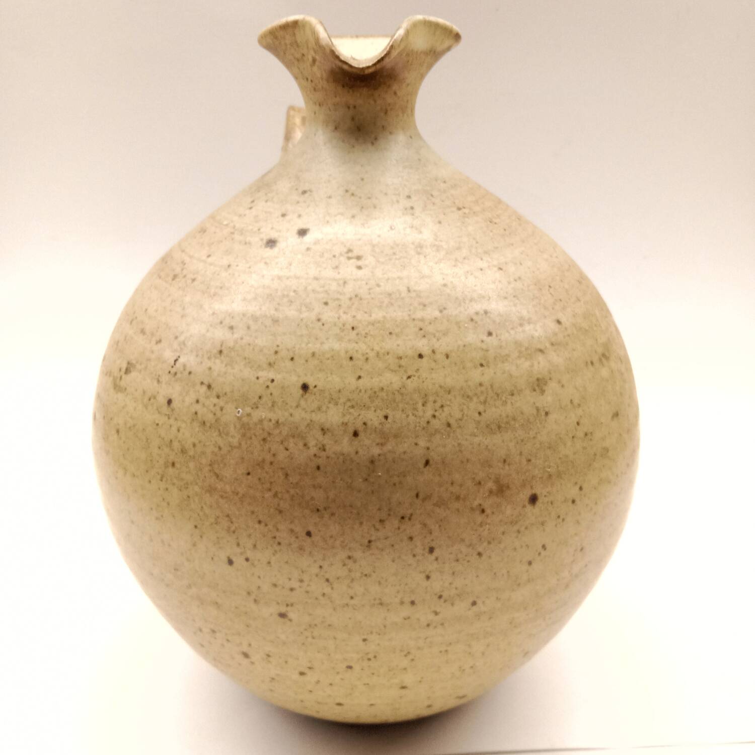 Vintage speckled brown stoneware jug in a round shape.
