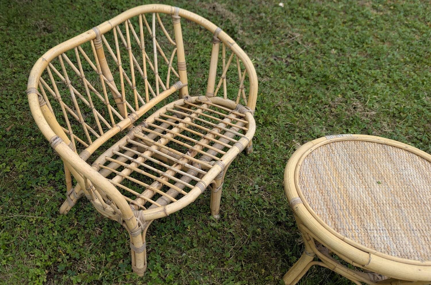 Set of children's rattan garden furniture from the 1950s and 1960s, including chairs, table, and bench.