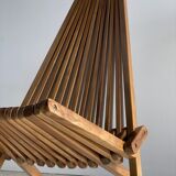 Foldable designer armchair in wooden slats