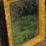 Wooden mirror decorated with gold from the 1920s