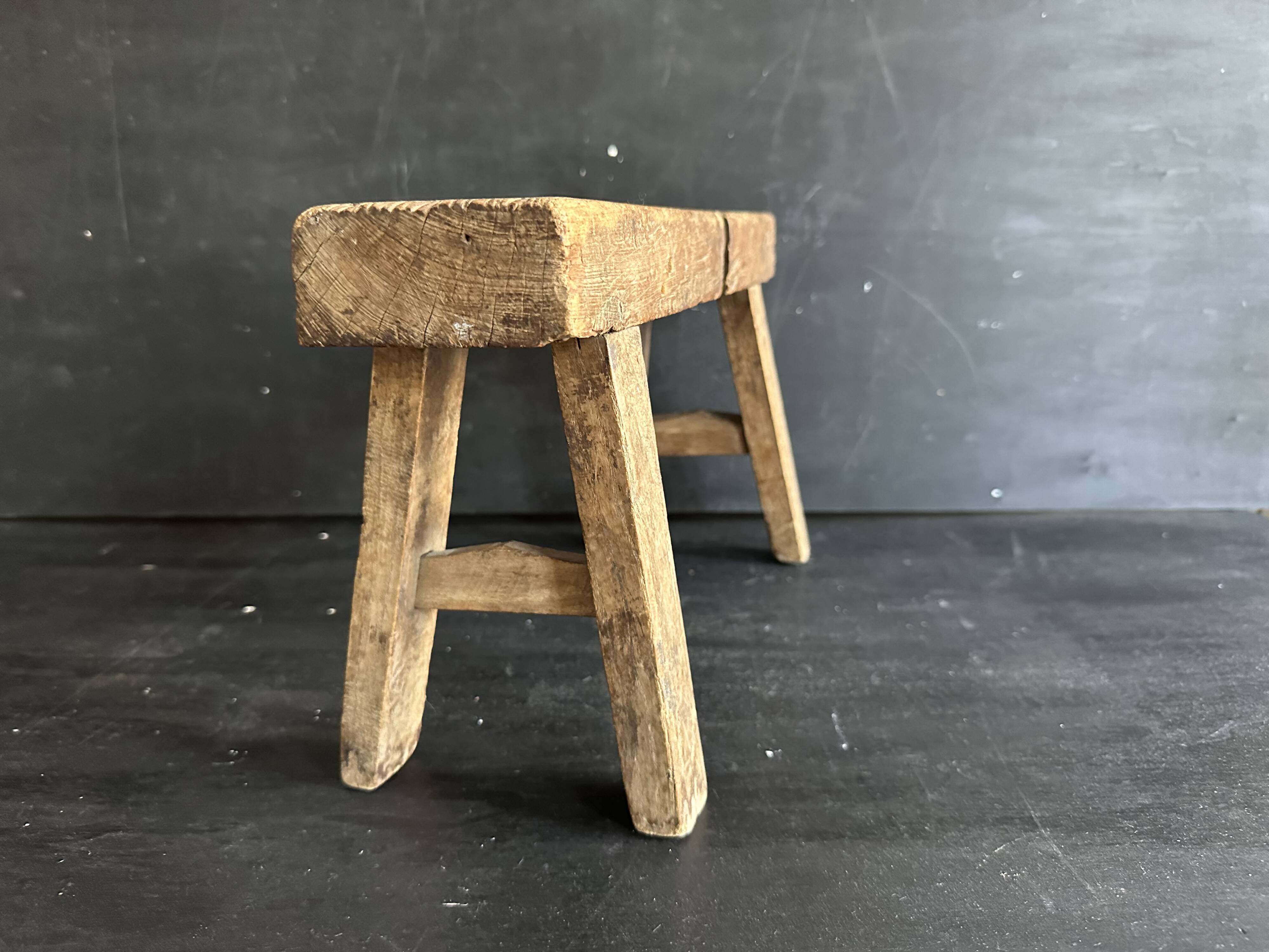 Ancient Chinese farm bench in patinated wood, small rustic stool.
