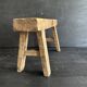 Ancient Chinese farm bench in patinated wood, small rustic stool.