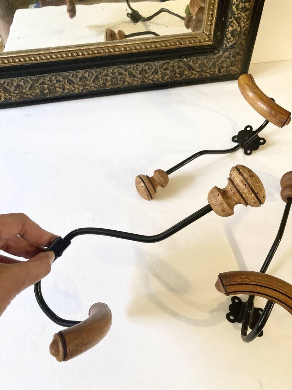 Trio of antique wooden and metal coat hooks