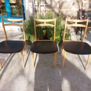 3 Scandinavian style chairs, light wood and black faux leather.