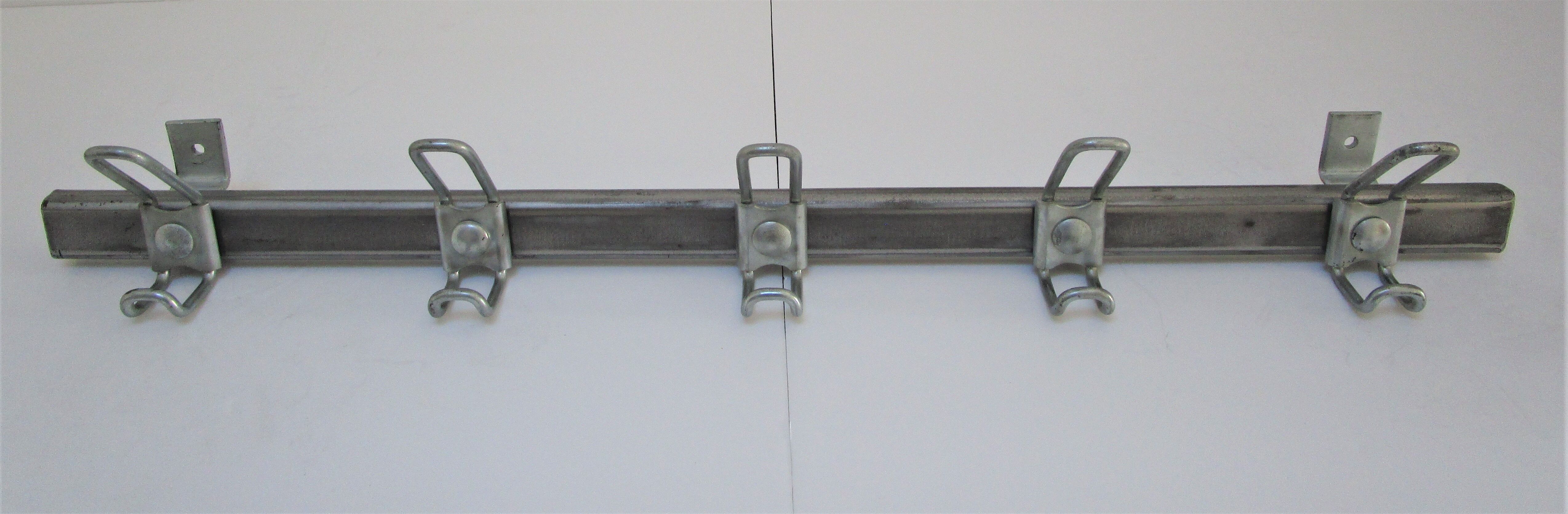 Vintage school wall rack in patinated steel