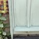 Cloakroom with sage green wall coats
