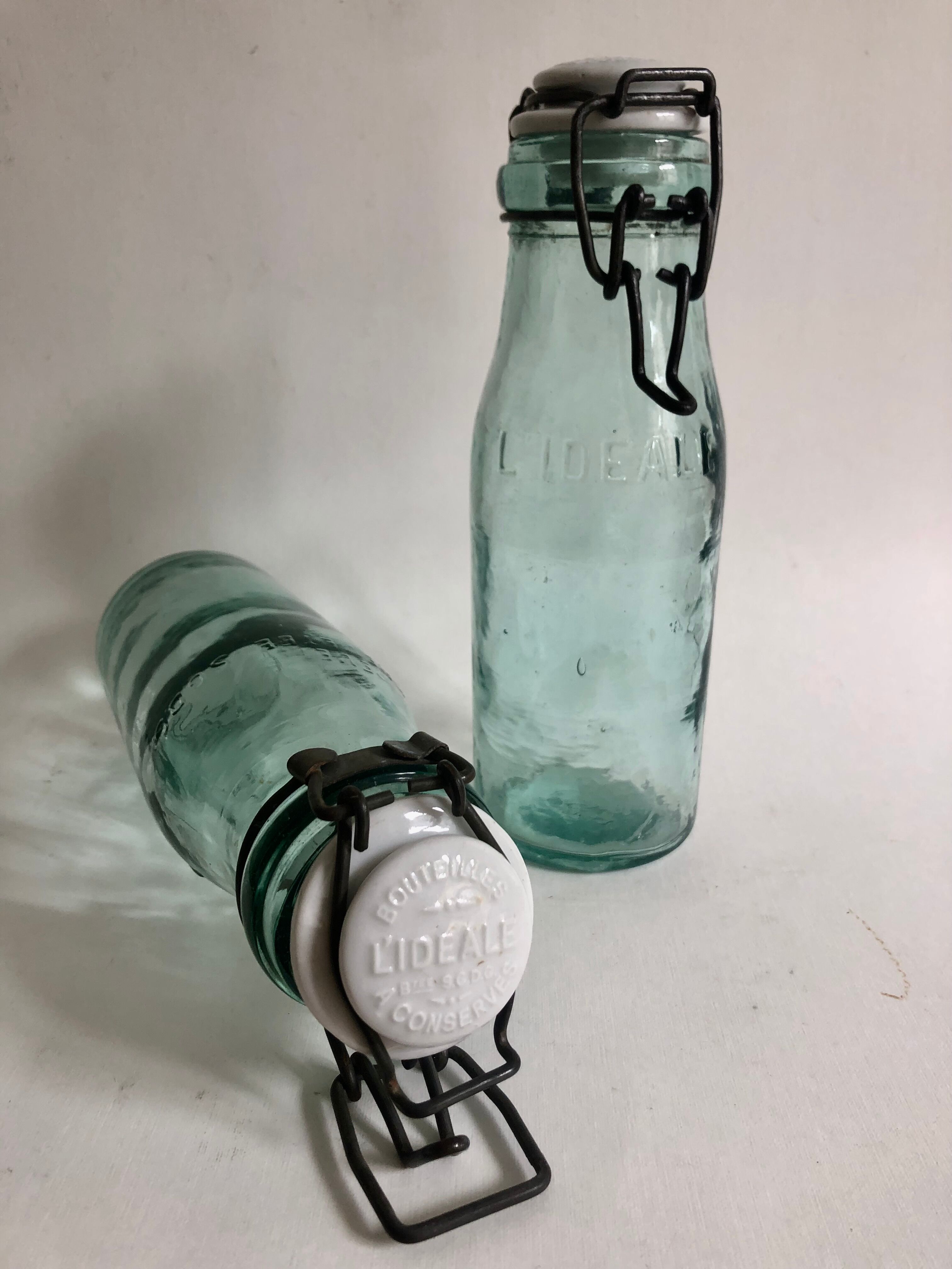 Two bottles with canned goods l'ideale