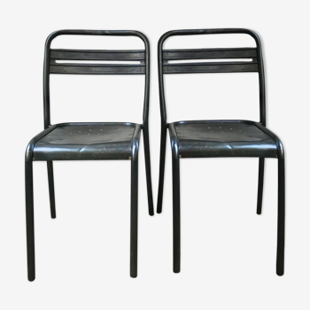 Pair of industrial chairs in raw stripped metal