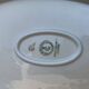 Large yellow porcelain serving dish by Bernadotte from the 1960s, with a gold rim and relief.