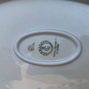 Large yellow porcelain serving dish by Bernadotte from the 1960s, with a gold rim and relief.